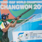Male Athlete, Nathan Argiro competing at World Championships, in position holding his shot gun up ready to fire.