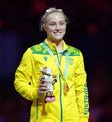Australian gymnast Emily Whitehead smiling for a photo on the podium.