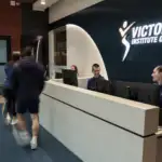 A photo of the VIS reception desk with two people sitting behind the counter.